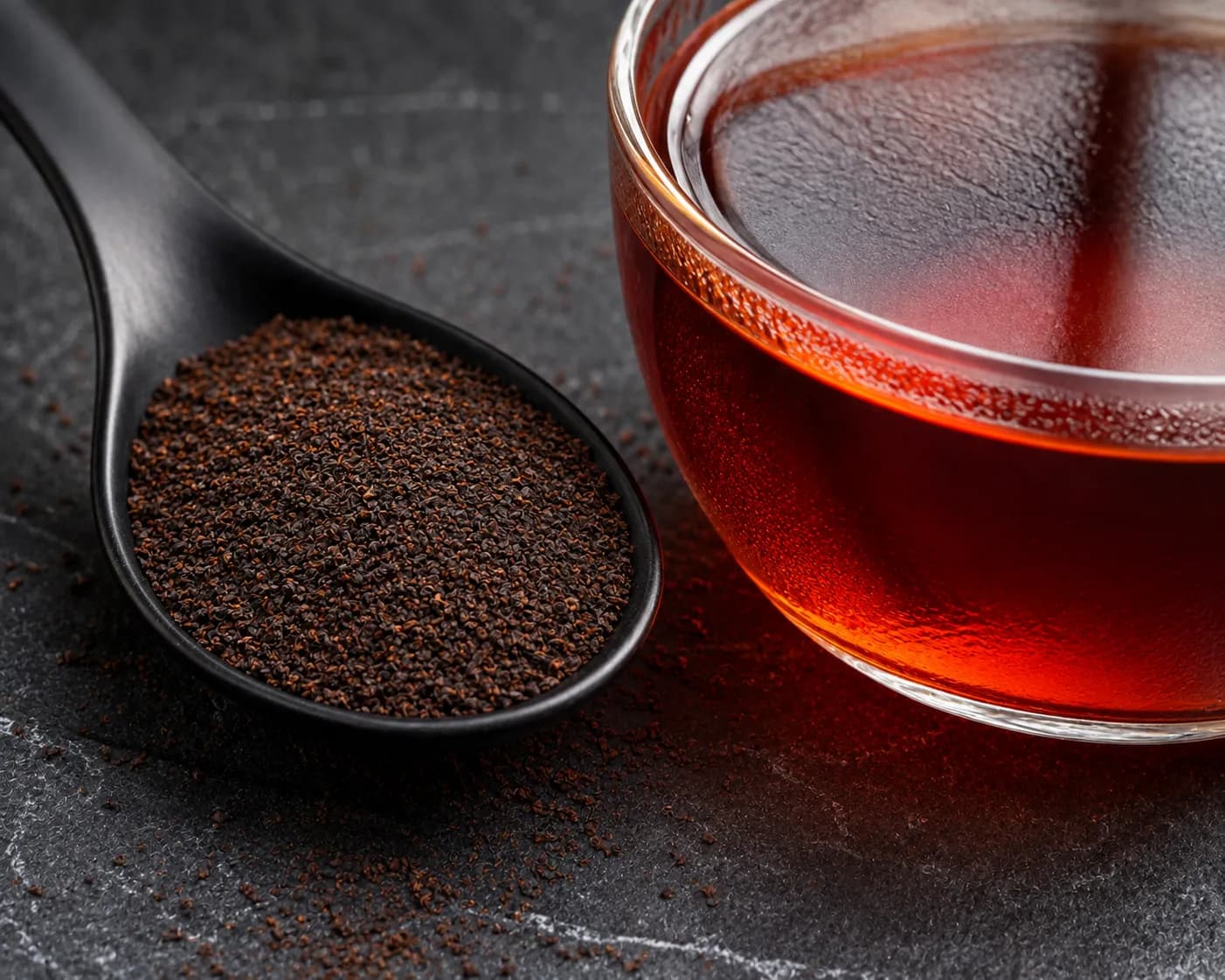 Ceylon BOPF Broken Orange Pekoe Fannings tea particles with intense ruby red liquor